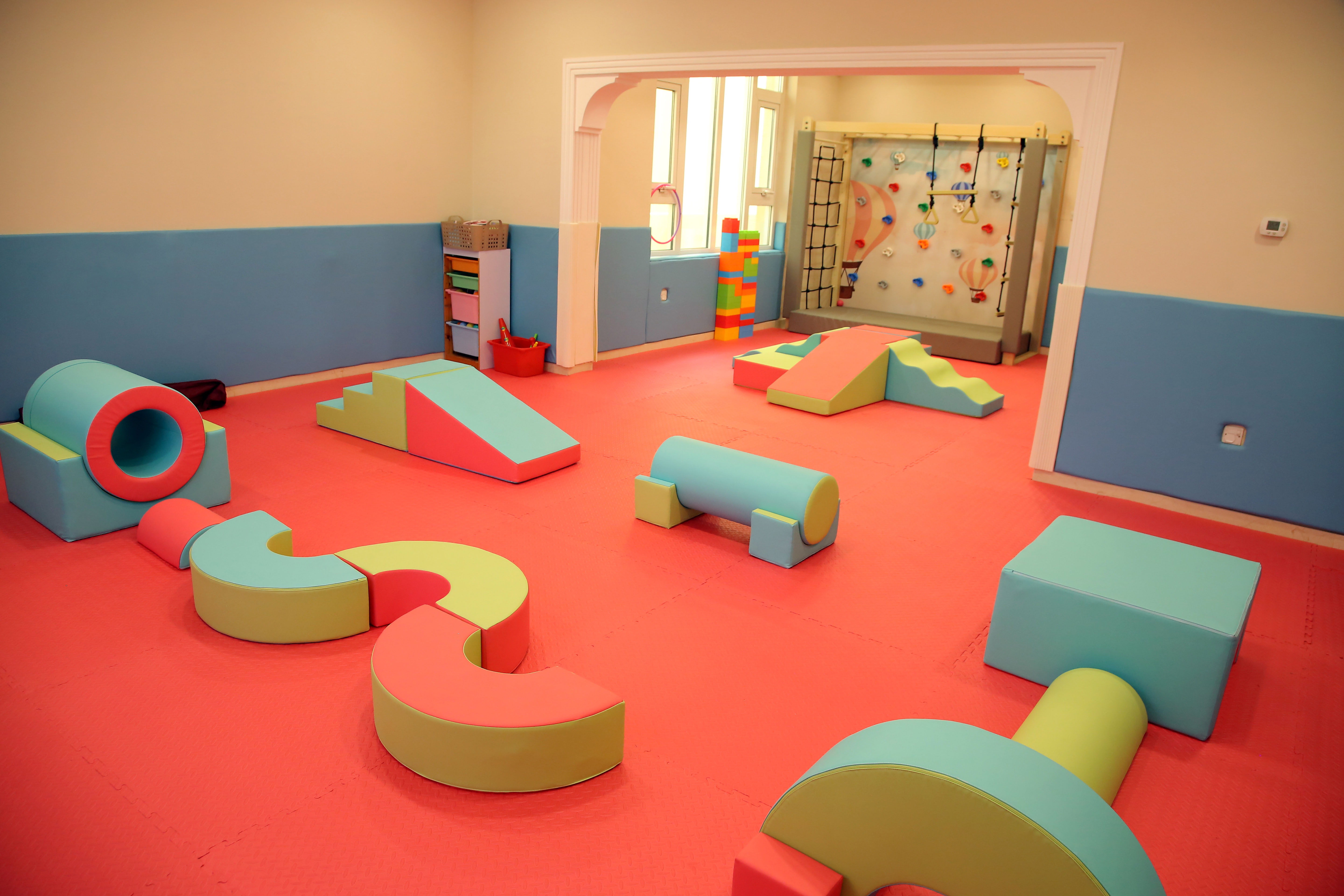 Indoor soft play room with colorful foam blocks and slides